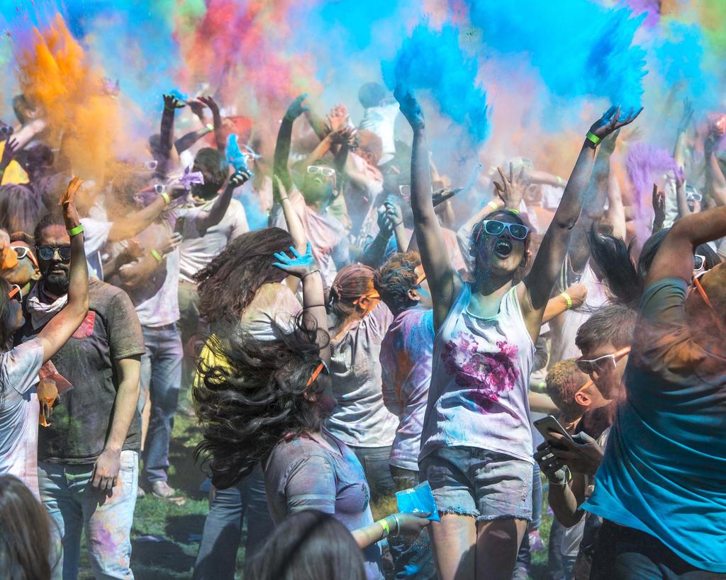 Holi Moli celebration by group of Mason students covered in colorful powders.